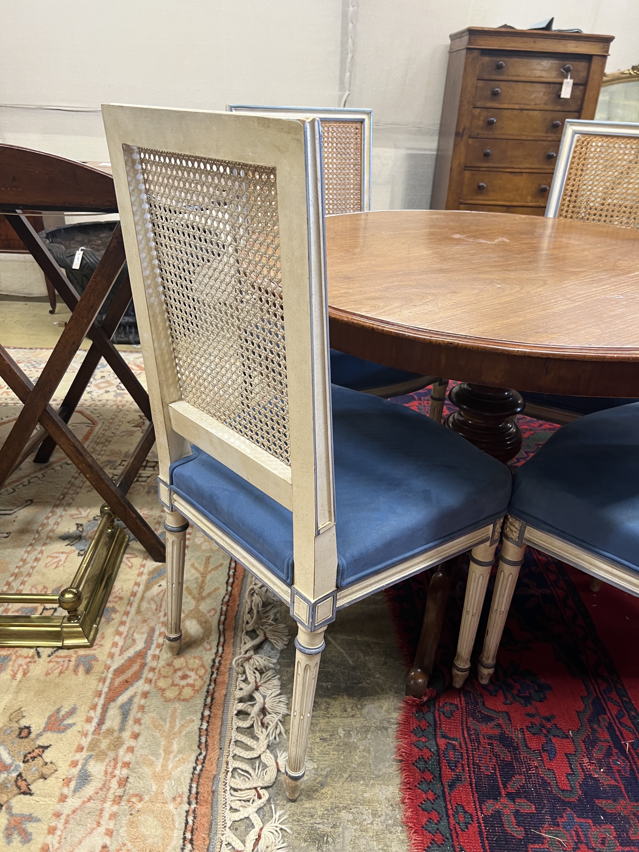 A set of four French style painted caned back dining chairs